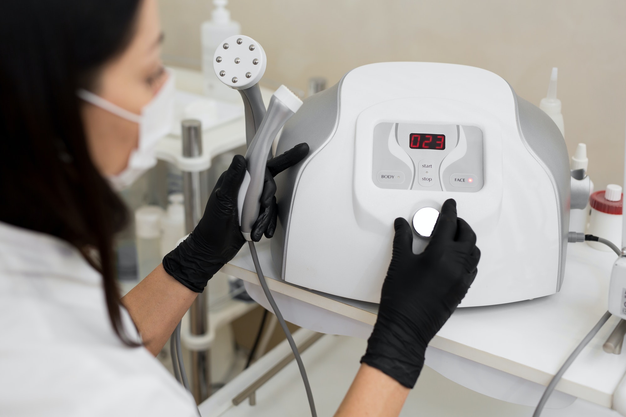 Close-up of a cosmetologist includes a mesotherapy medical device. Close-up of medical equipment in